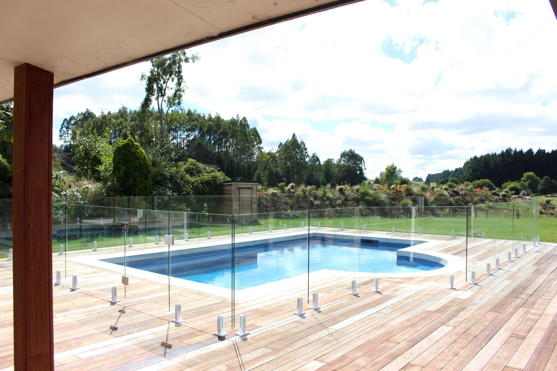A designer inspired glass pool fence supported by Juralco's Edgetec® Balustrade Mini Post Clamps.