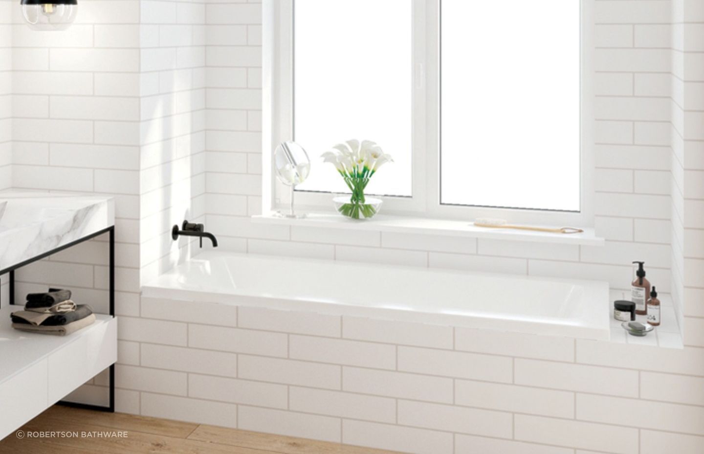 A sleek drop-in bath from the Elementi Collection by Robertson Bathware, neatly installed in an alcove space.