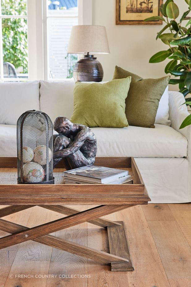 This coffee table's organic tones perfectly complement the room's interior style. Featured product: Cross Leg Coffee Table.