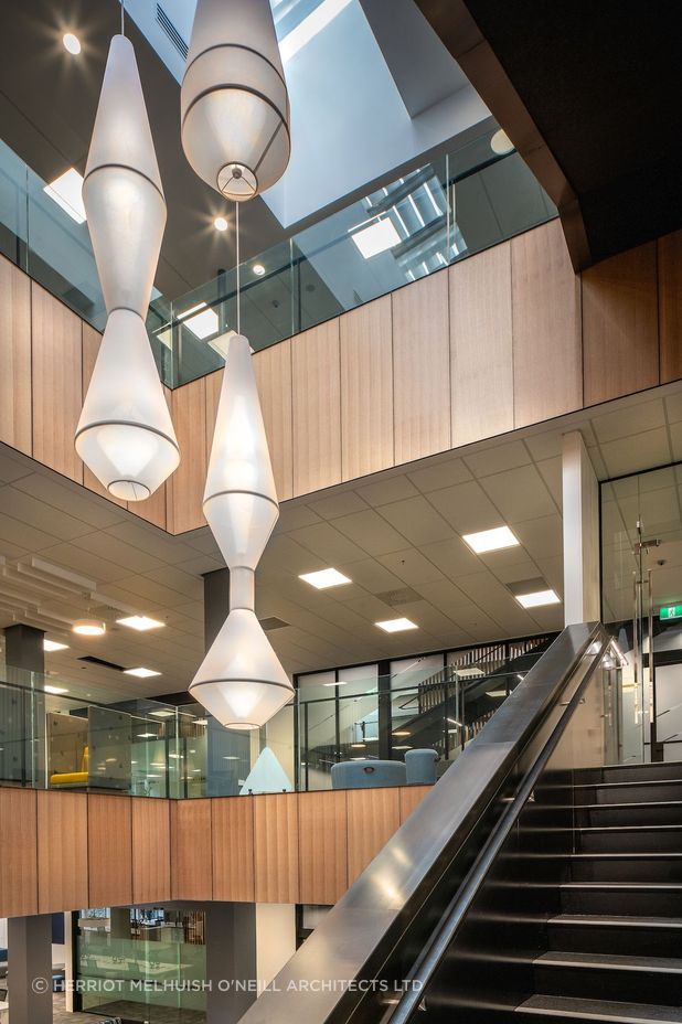 Stretching across a city block in the heritage-listed Harbour City Centre, HMOA has created three levels of new office space for FNZ's New Zealand headquarters.