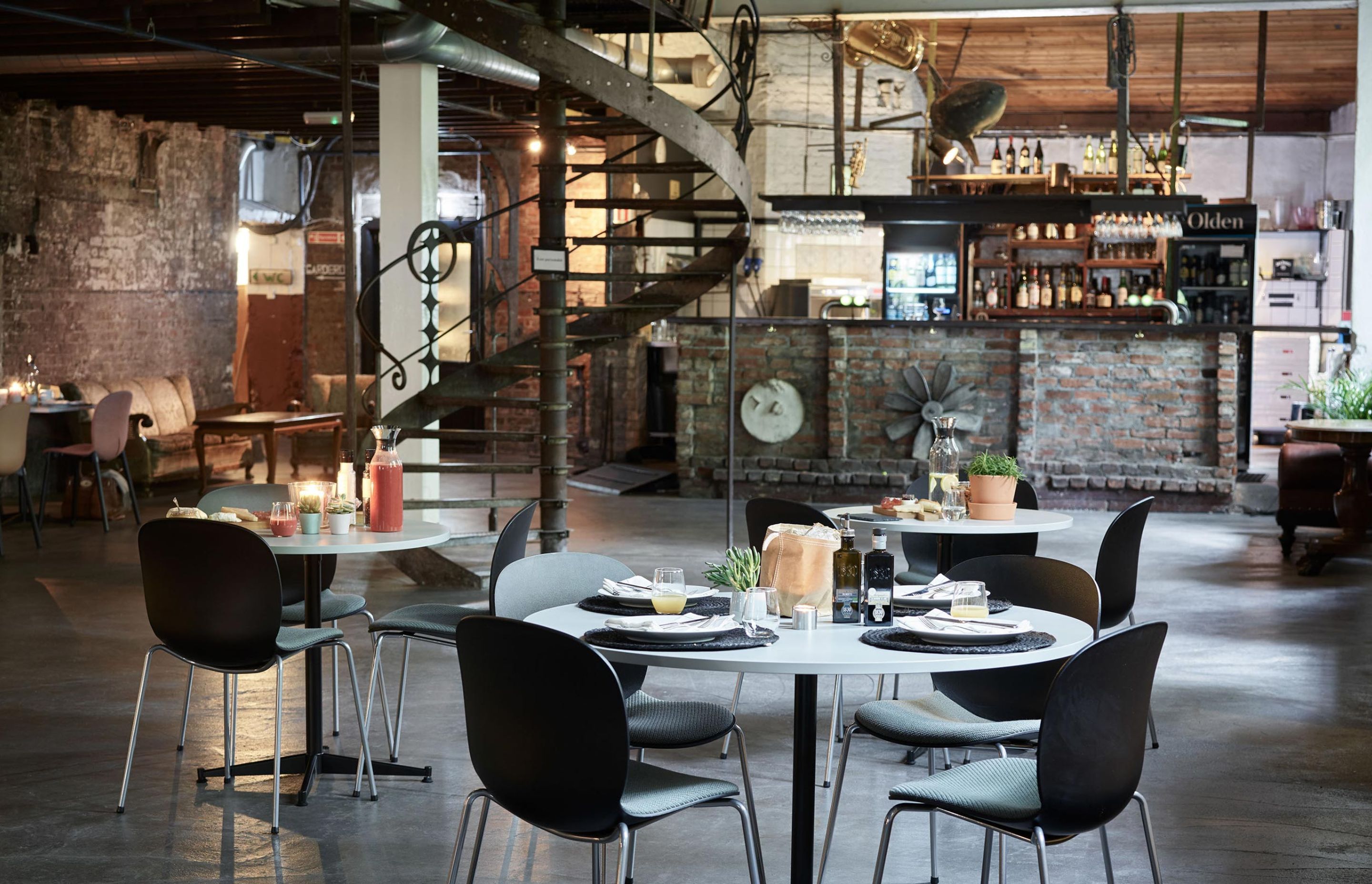 A rustic cafe scene, complete with bare brick walls and RBM Noor chairs