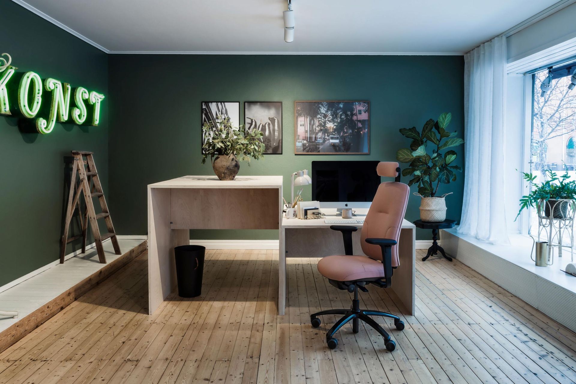 Or how about a funky solo office with vibrant green walls and neon sign, featuring RH New Logic chair