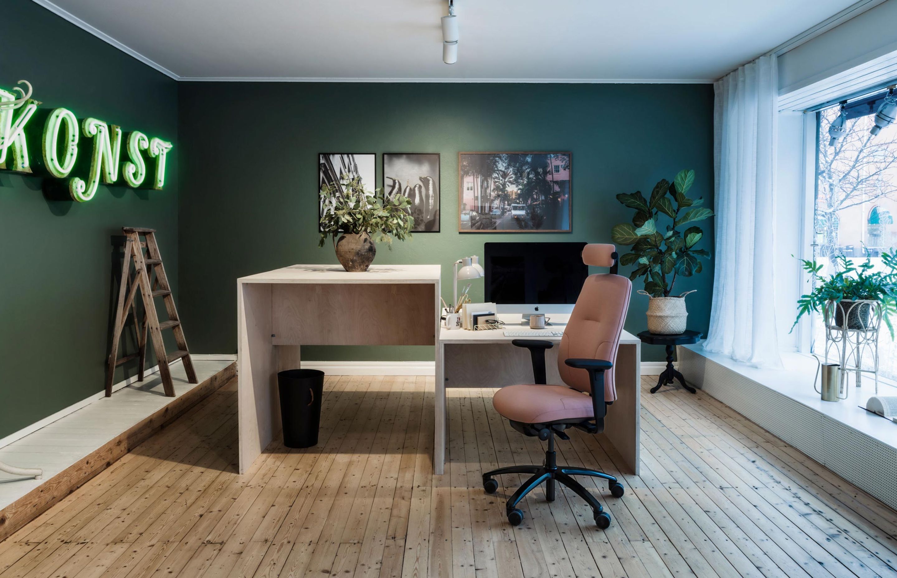 Or how about a funky solo office with vibrant green walls and neon sign, featuring RH New Logic chair