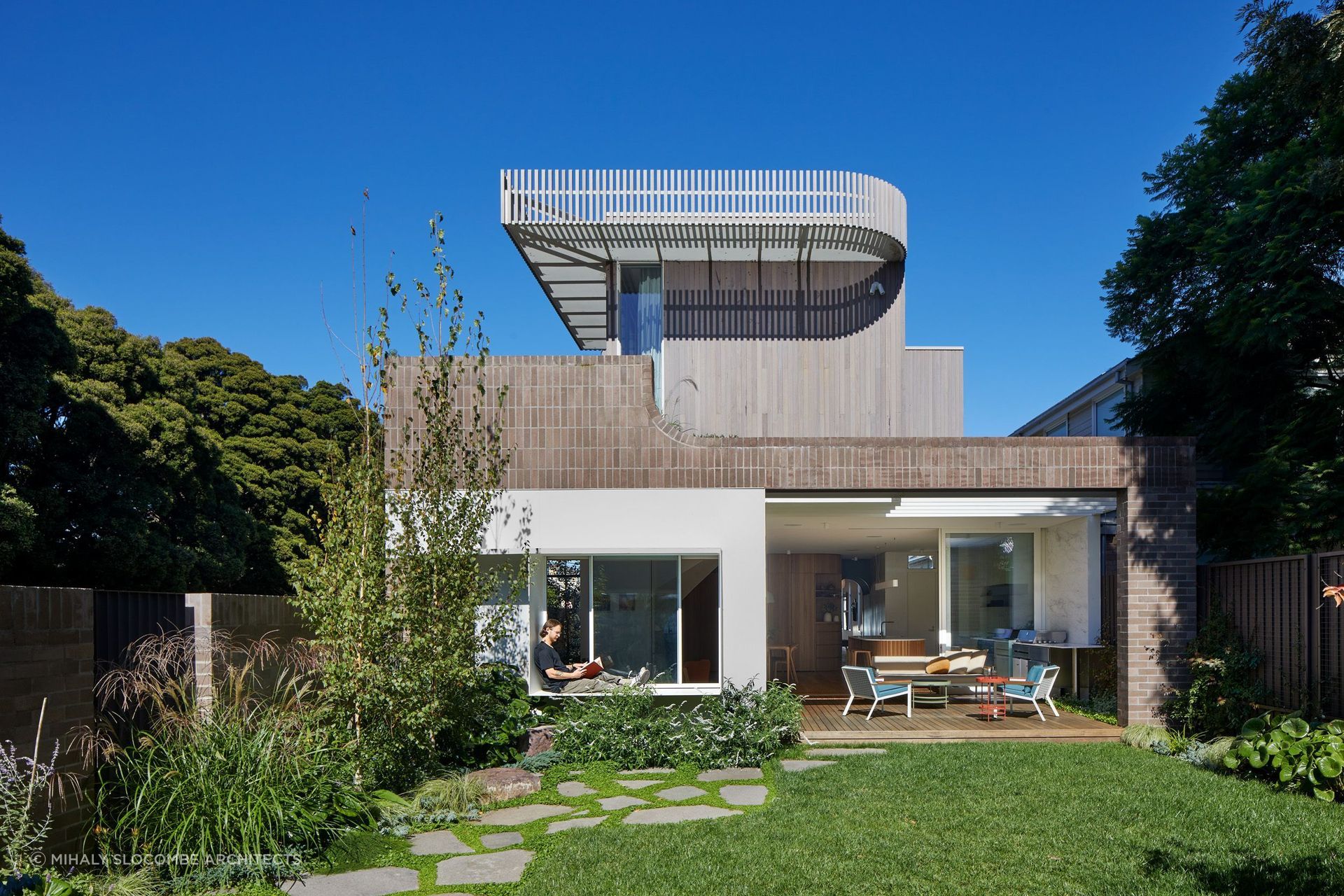 A sculpted extension of an unassuming weatherboard cottage by Mihaly Slocombe Architects.