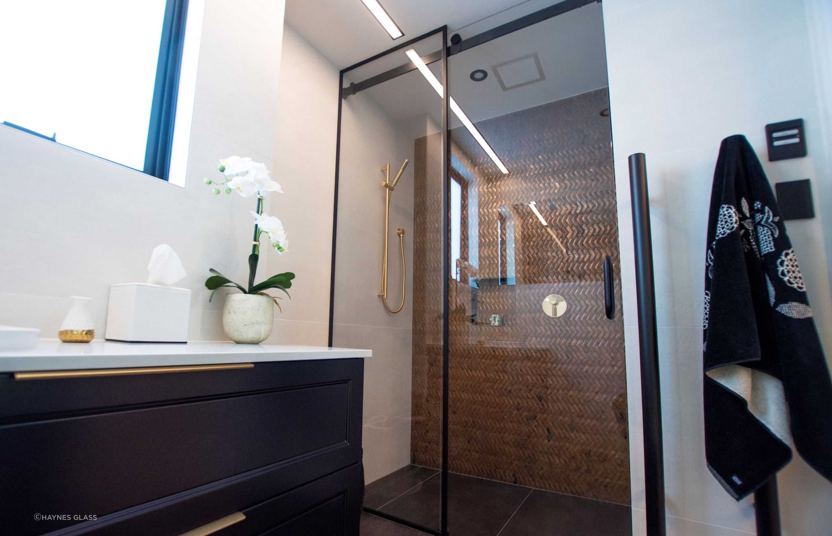 Sliding doors are great space savers and can be used as the entry door to your bathroom or for your shower as seen here.
