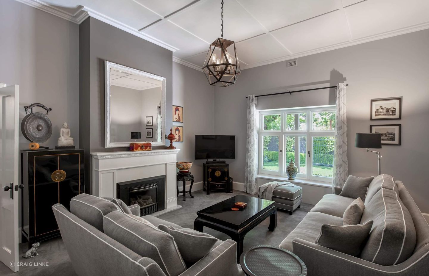The neutral hue of the sofas fit well in this stylish grey living room exude a sense of calm and sophistication. Featured project: Weybridge House.