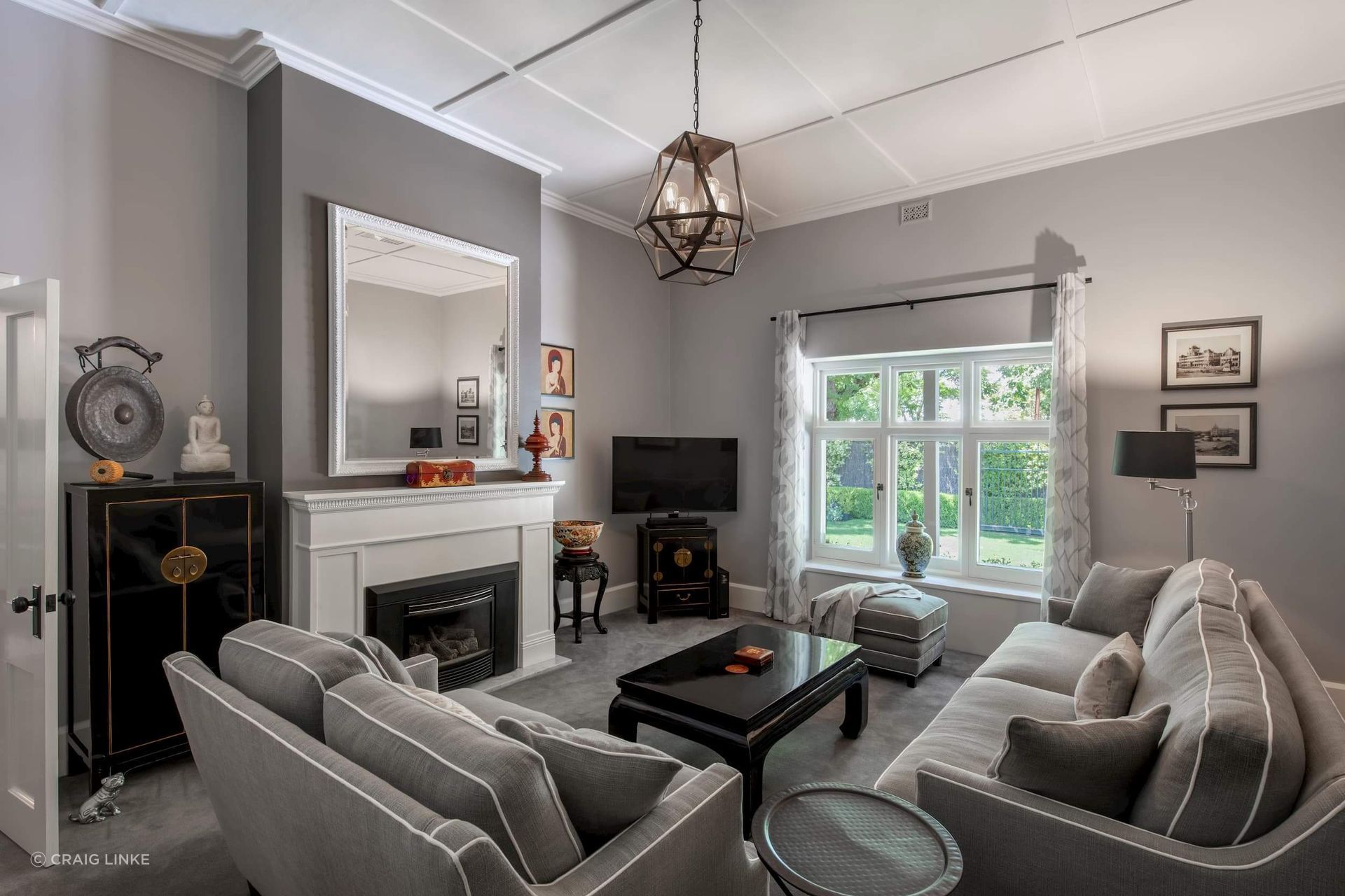 The neutral hue of the sofas fit well in this stylish grey living room exude a sense of calm and sophistication. Featured project: Weybridge House.