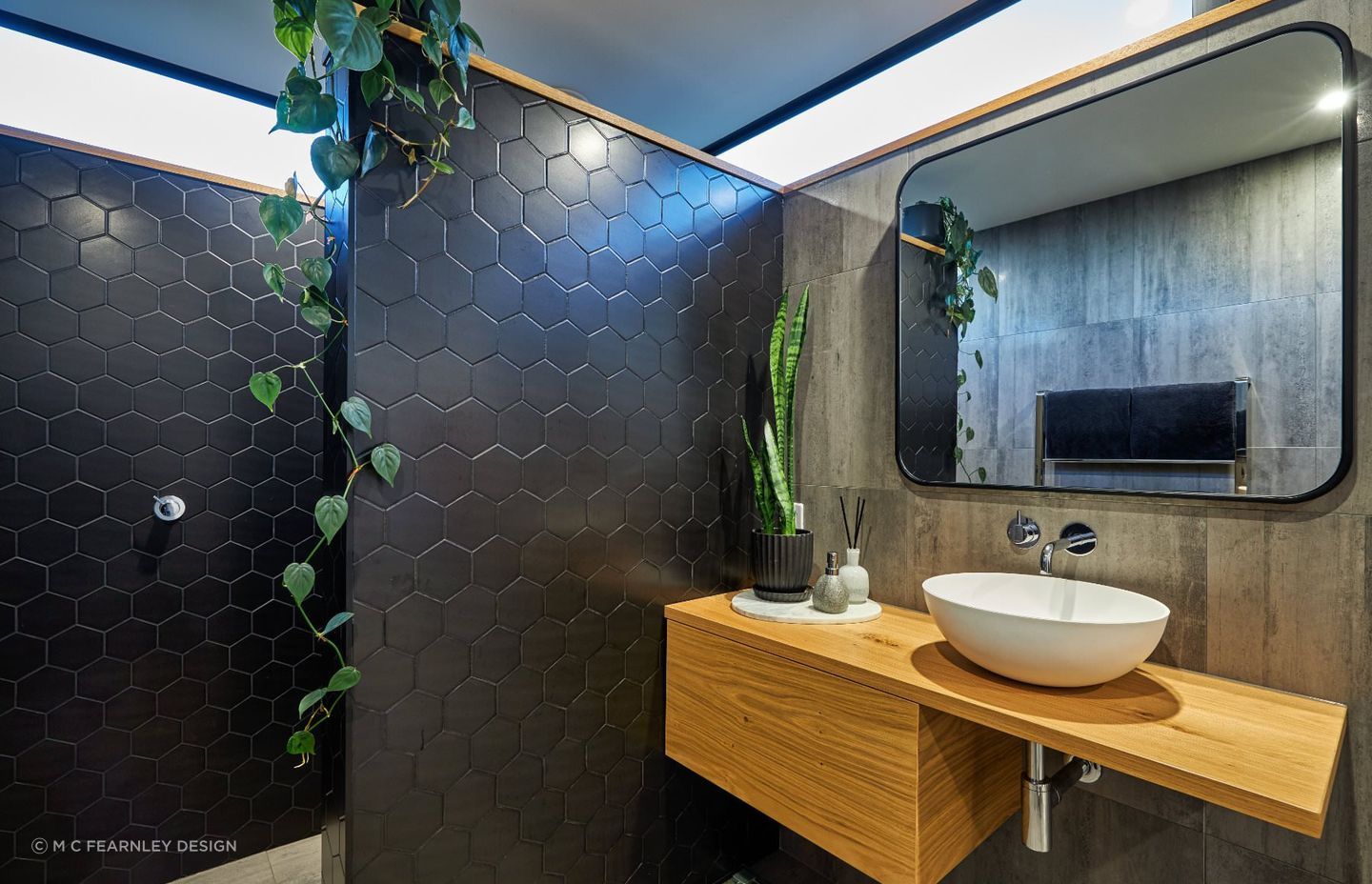 A strategically placed climbing plant and well poised pot plant are inviting additions to this Hapuku home bathroom — Photography: Andrew Spencer