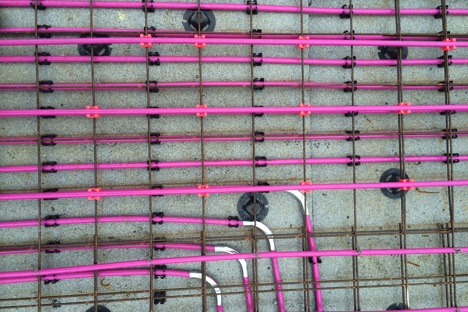 The underfloor systems are all custom-designed by qualified heating engineers. Instead of using radiators to heat a room, hot water pipes are laid either into the concrete floor slab or under wooden floors between the joists. This warms the slab/floor, providing a warm floor and radiant heat in the room.