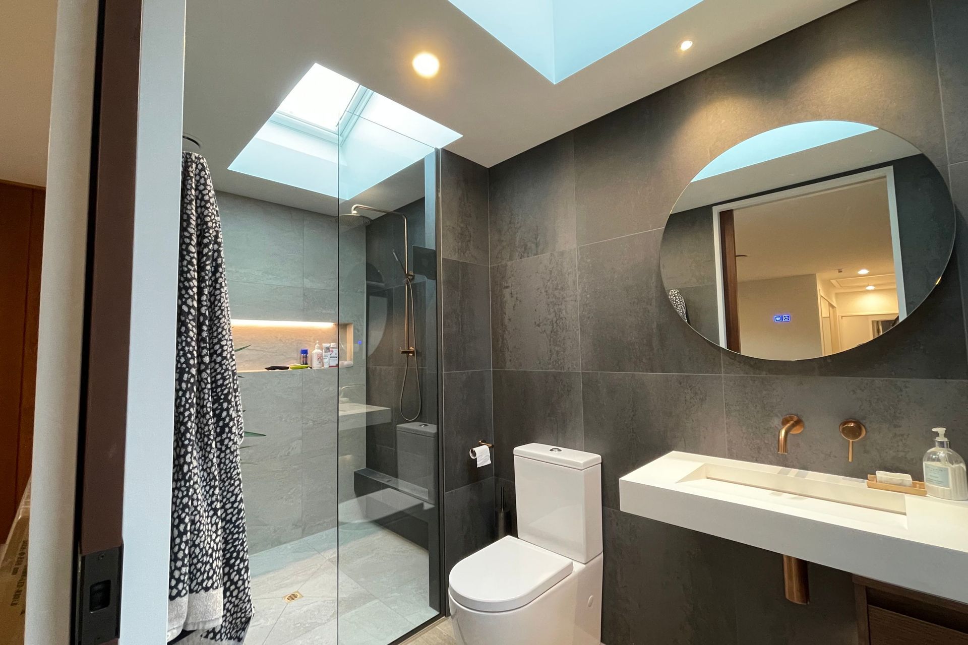 Recessed tiled shower shelves offer storage in a modern way while not encumbering the space.