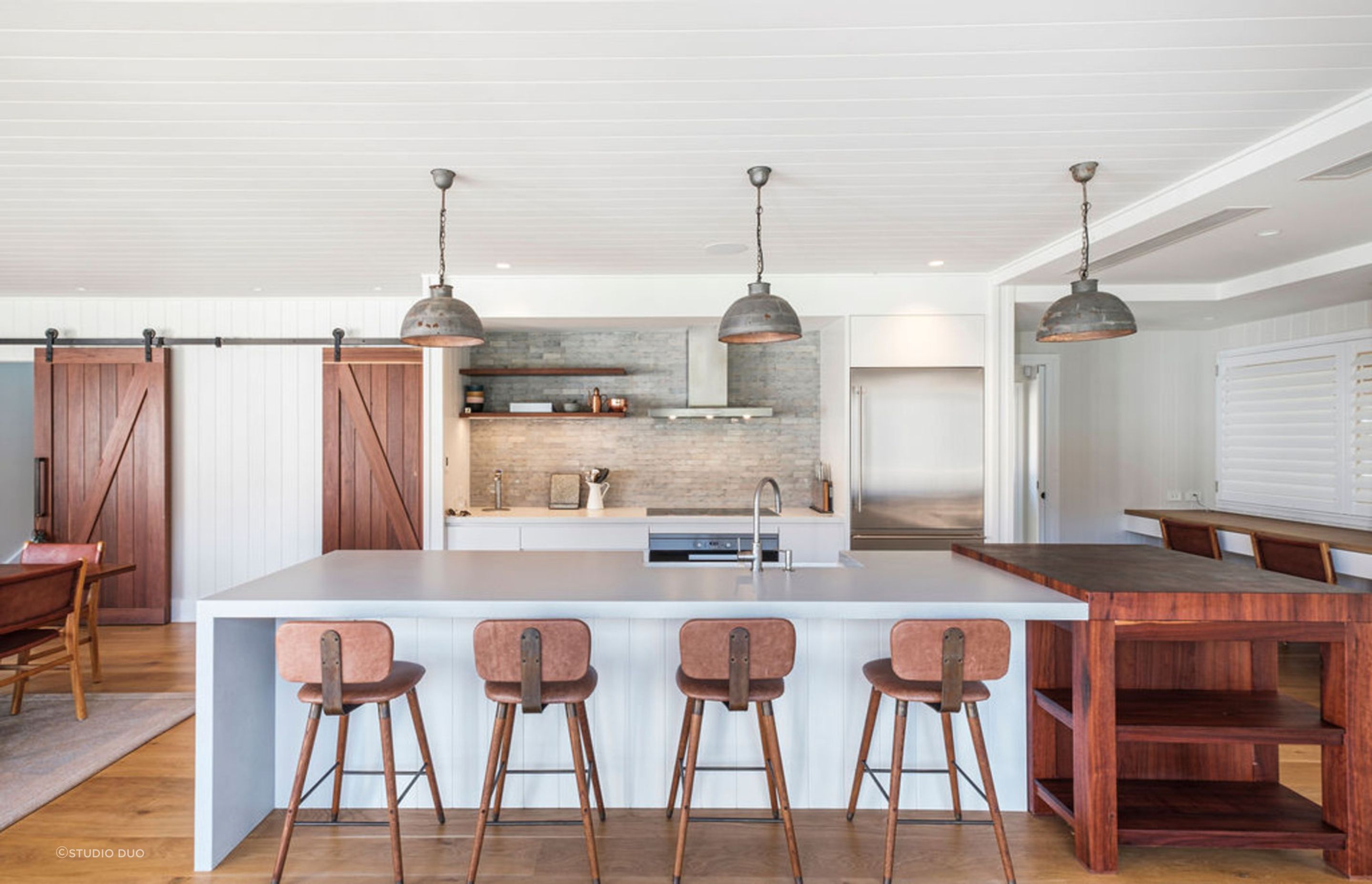 Industrial or farmhouse pendant lights add a rustic appeal to a kitchen.