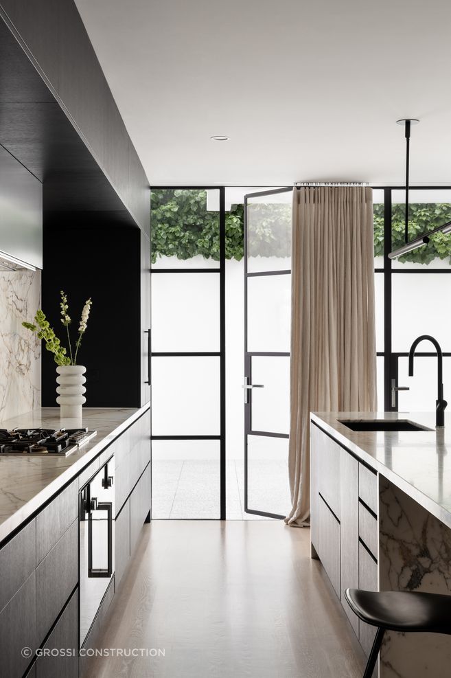 Materials such as metal, marble, and layered finishes are common in AKI's interiors.
