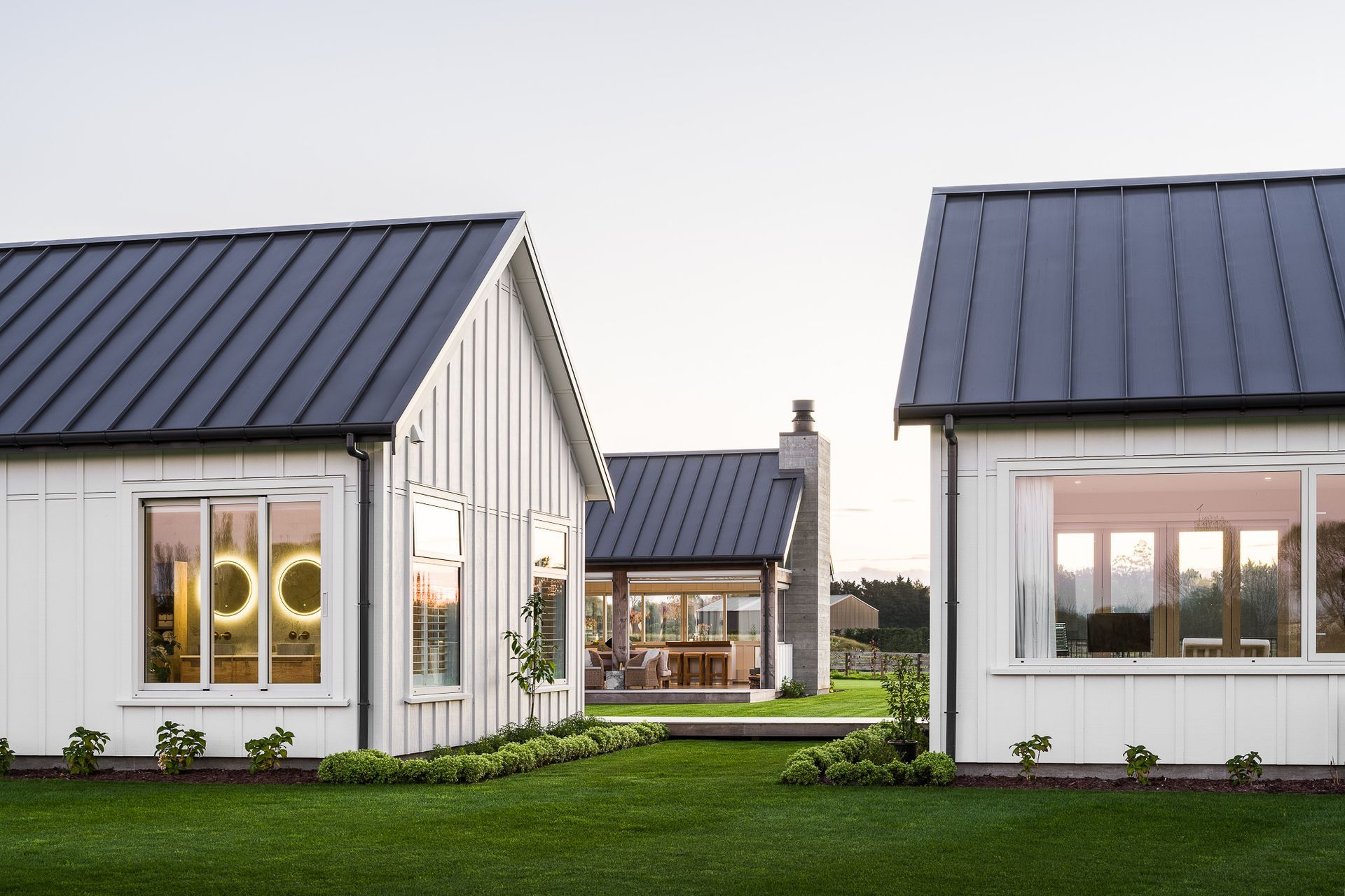 The gable forms in this Christchurch home are elevated by the tray roof, giving the buildings a sophisticated appeal.