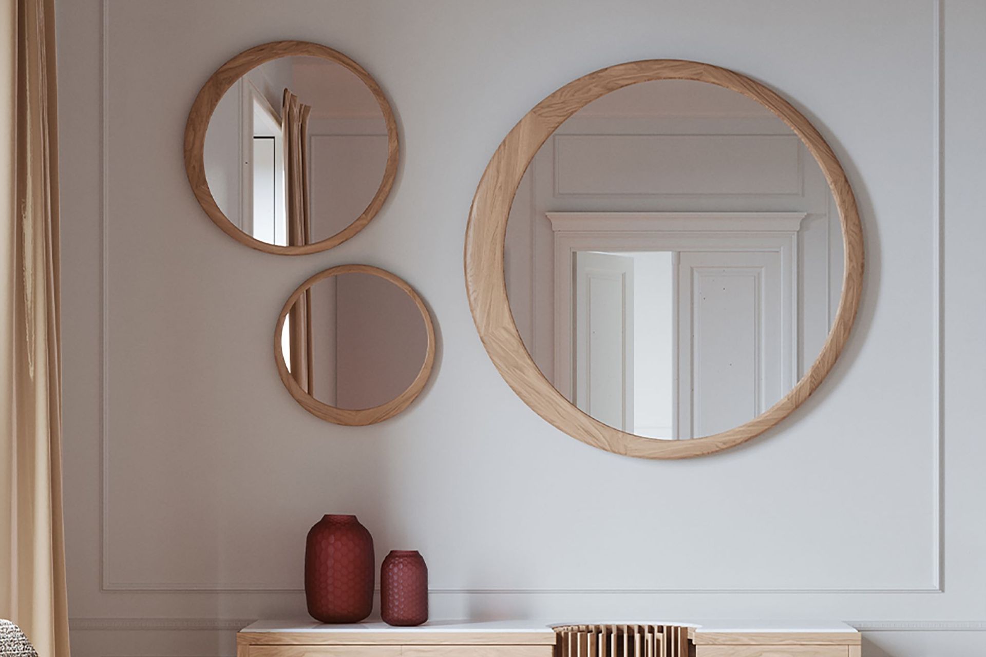 A wall mirror, or three, can reflect natural light in a bedroom for a brighter space, seen here with the stylish Luna Round Mirror.