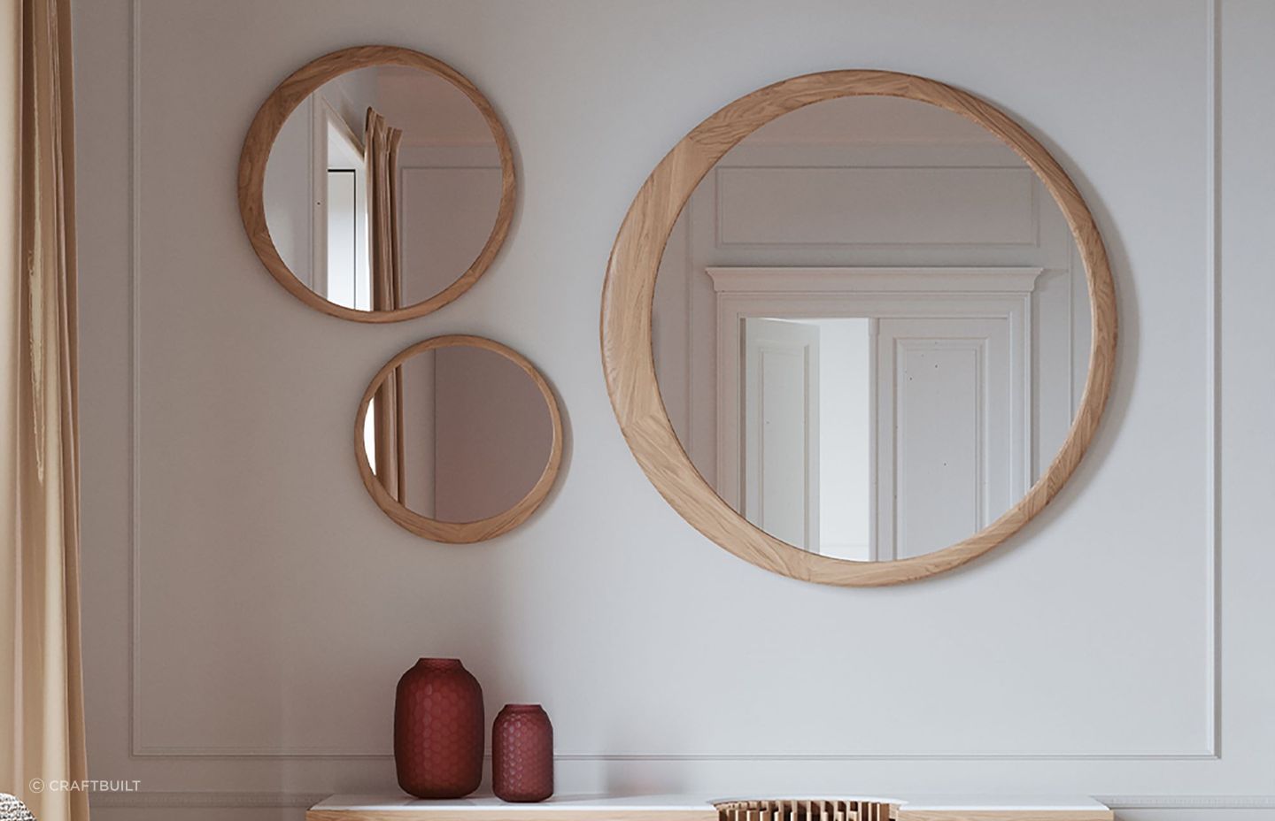 Different sized models of the Luna Round Mirror, gracefully combined together in this wall space.