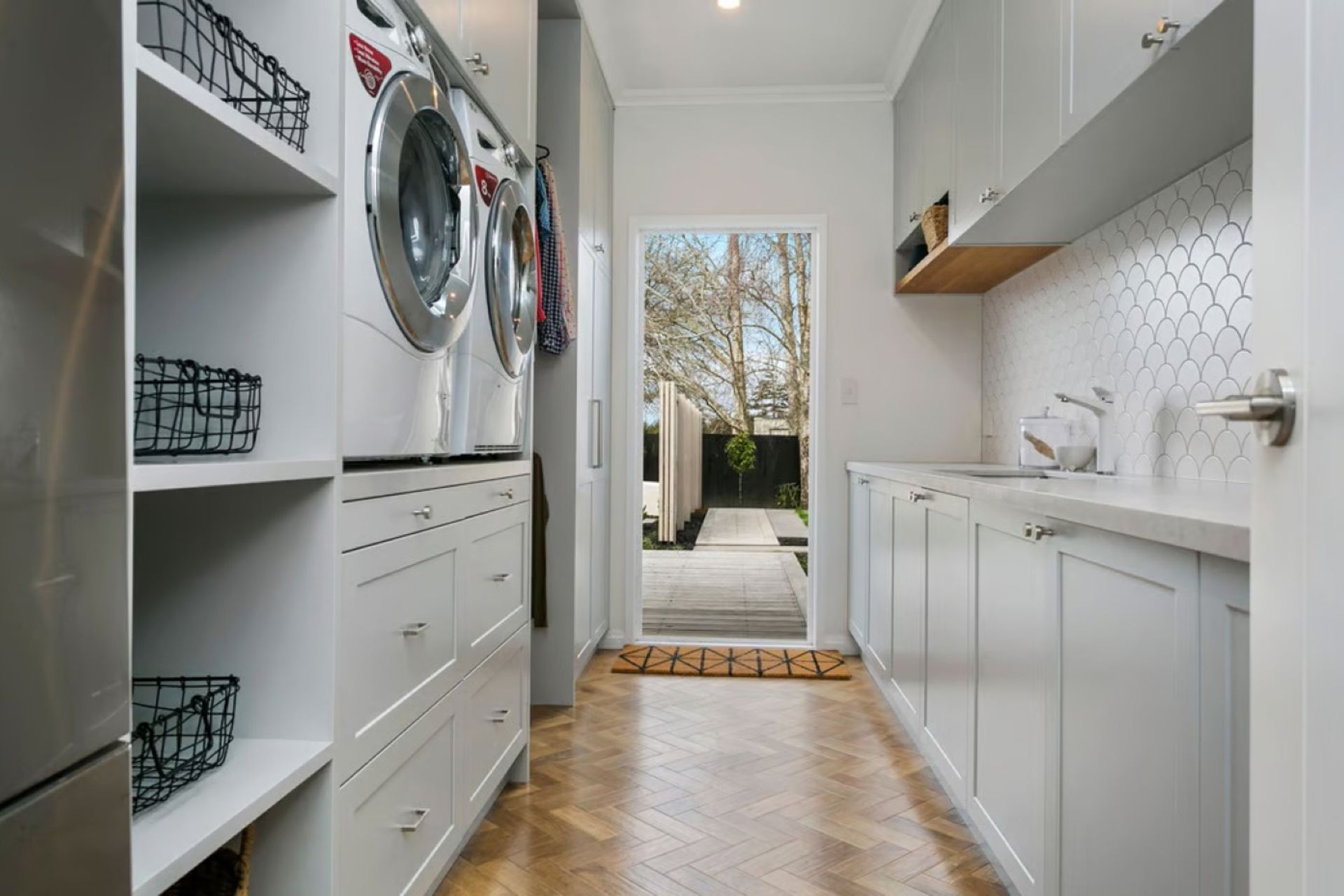 A great example of Herringbone flooring in the laundry space of this renovation project in Tamahere.