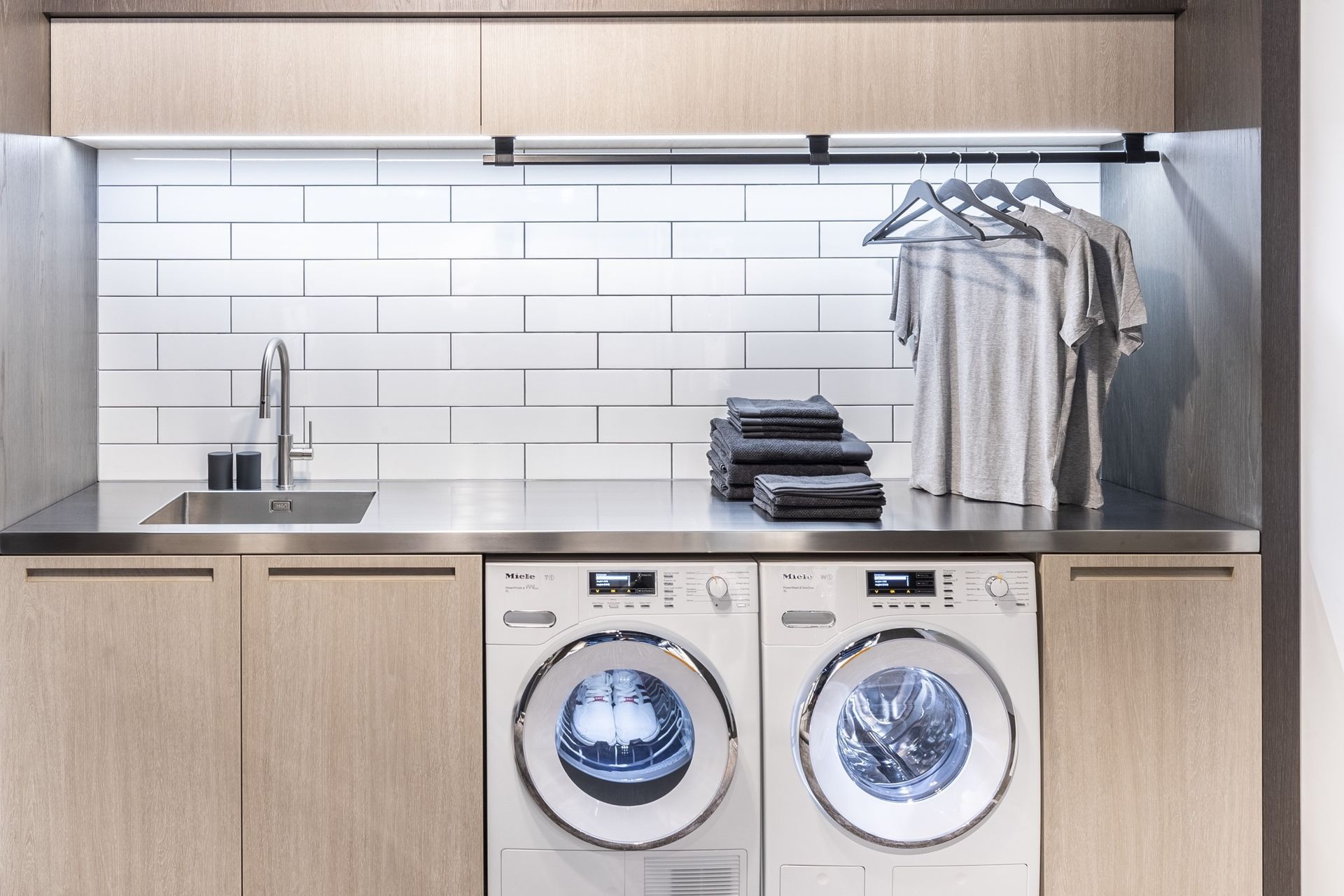 Classic subway tiles are a popular choice for a laundry splashback, seen here in a laundry featuring the equally popular 9KG Condenser Dryer with Heat Pump Technology by Miele.