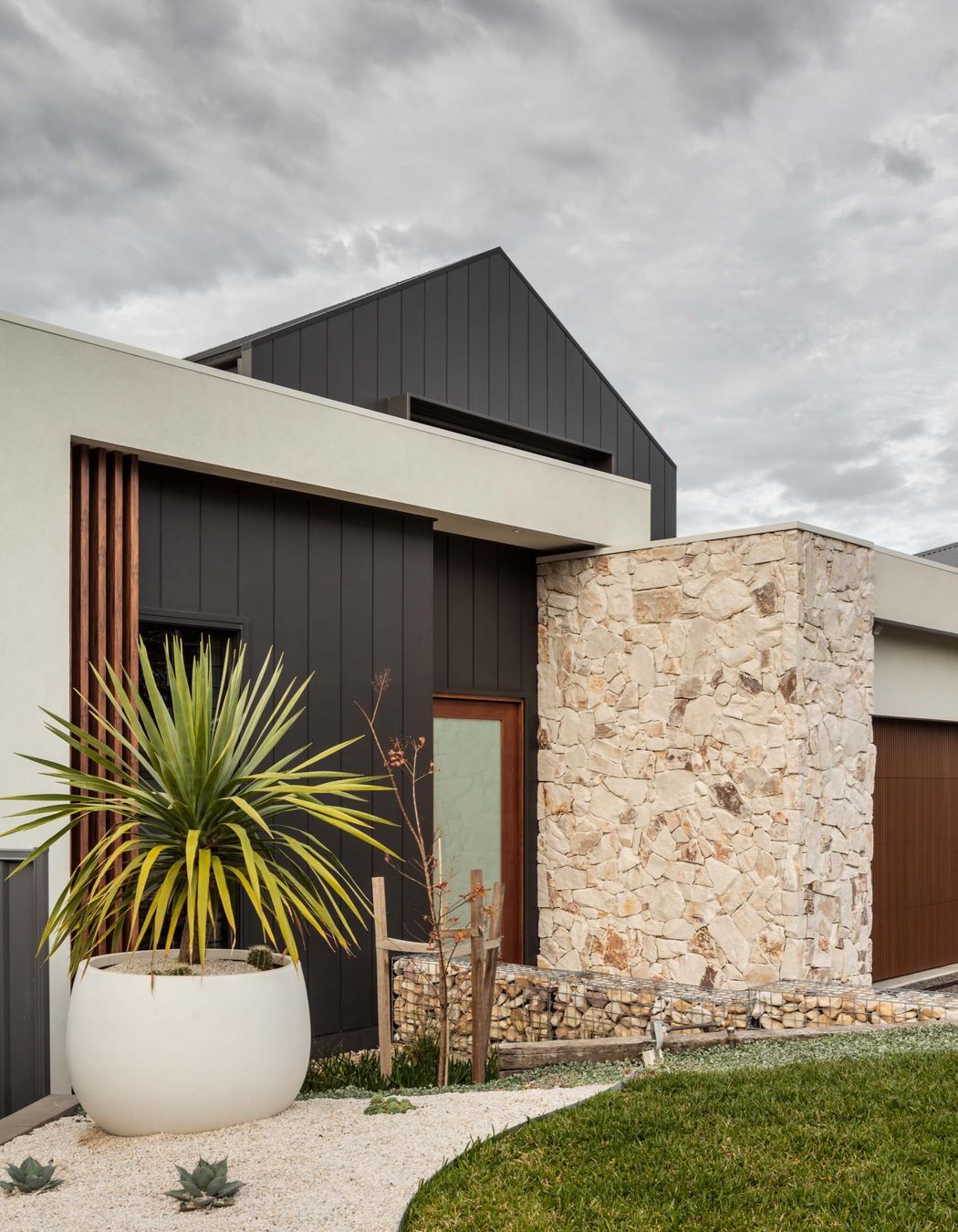 Natural stone cladding can is often used on a homes exterior in conjunction with other external cladding materials. Featured product: Callala Organic Stone Wall Cladding.