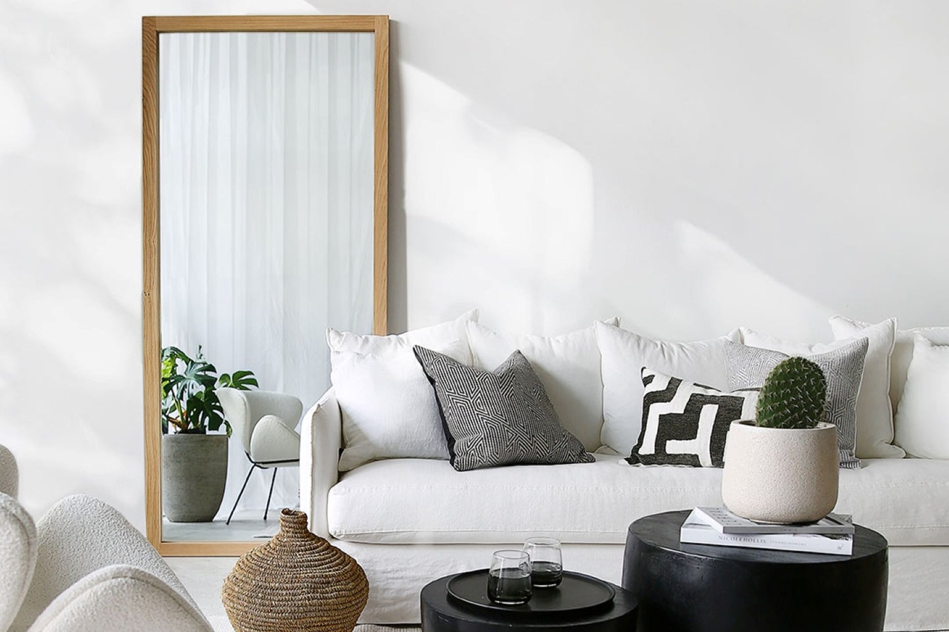 A strategically placed mirror, like this Oak Mirror from Indie Home, can enhance the sense of spaciousness.