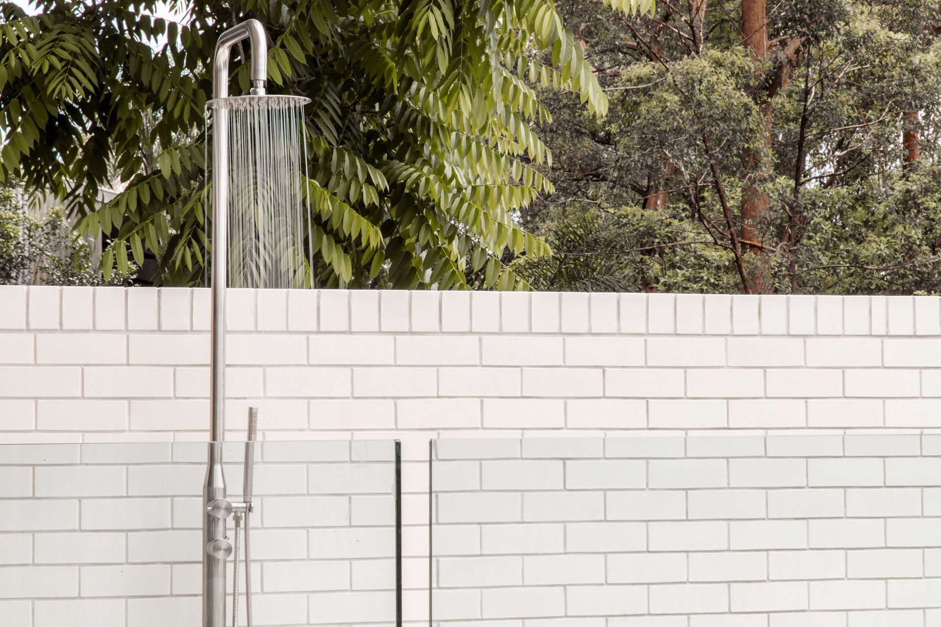 An outdoor shower head, typically made from weather-resistant materials, installed in a garden or patio setting offers convenient bathing after swimming, exercising, or gardening .Featured product: Sola Outdoor Shower Set