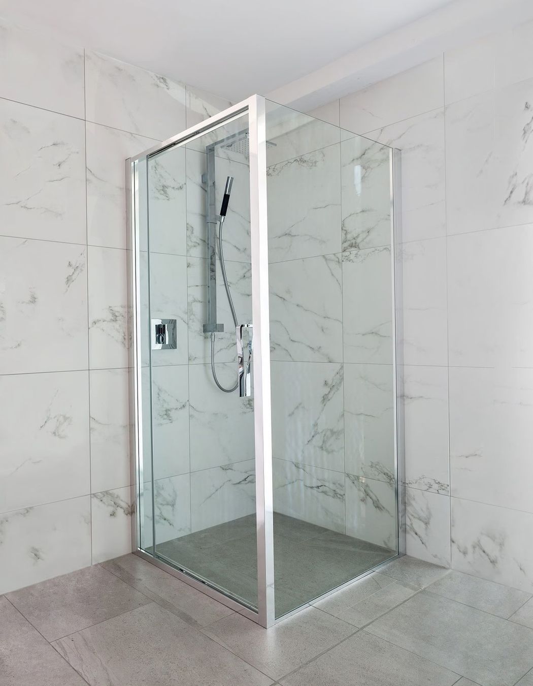 Pivot door shower screens can open inward or outward, depending on the positioning of the mechanism and hinge. Featured product: Torsion Square Corner Inswing Shower.