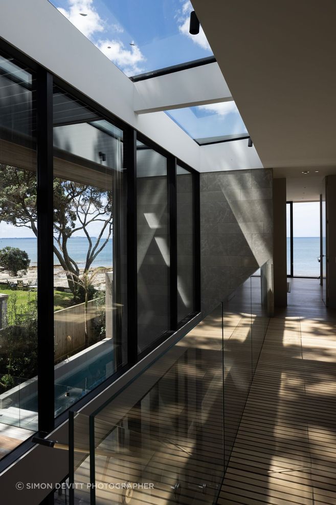The stairwell at Pohutukawa House features an entire wall of glazing on one side.