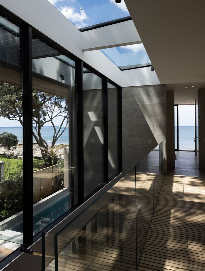 The stairwell at Pohutukawa House features an entire wall of glazing on one side.