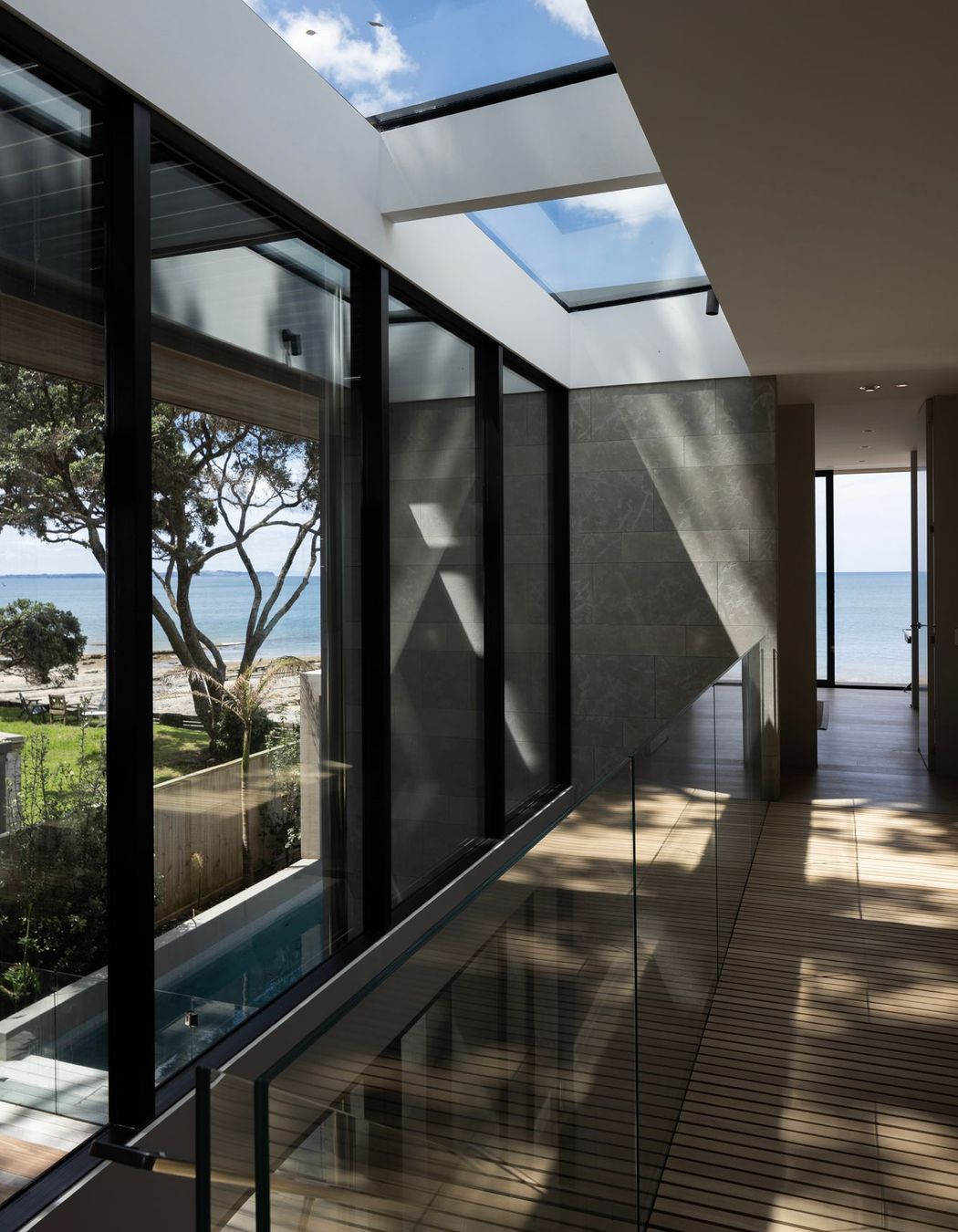 The stairwell at Pohutukawa House features an entire wall of glazing on one side.