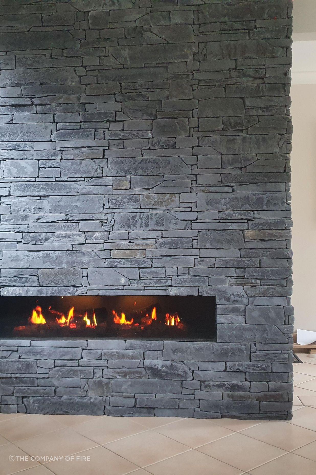 A modern electric fireplace integrated into a feature wall showcases the progression of fireplace design.