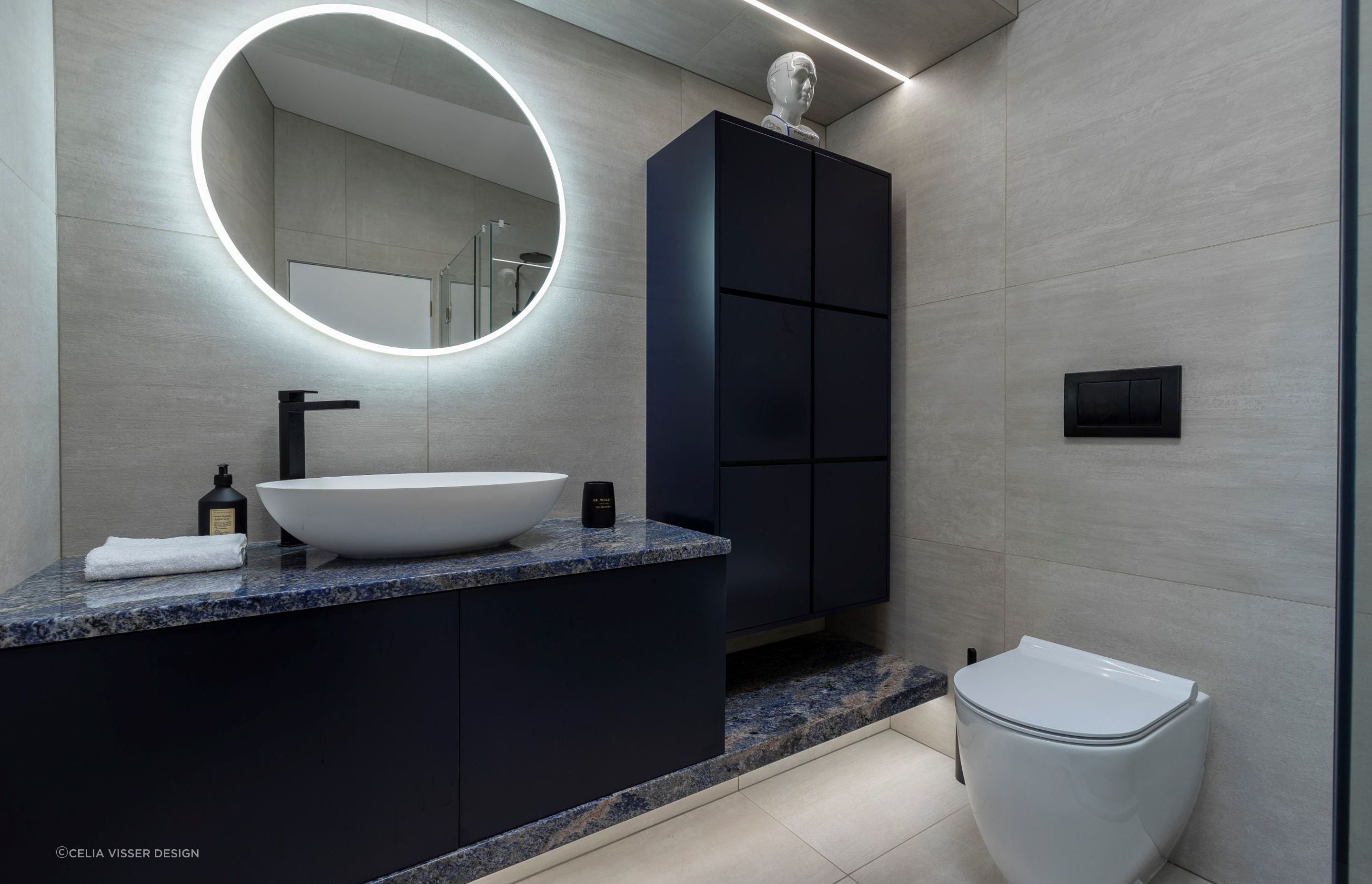 Employing a combination of different lighting fixtures can help eliminate dark spots that shroud a bathroom, expertly done in this Remuera bathroom.