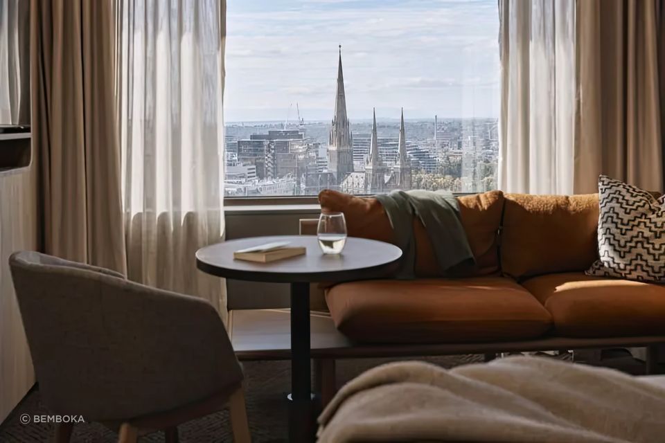 Layered window treatments featuring sheer and heavyweight curtains, seen at Rydges, Melbourne, designed to reflect light and block chilly winter drafts.
