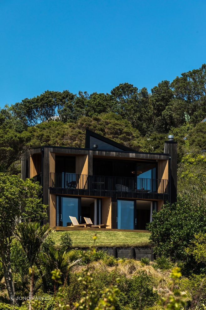 Nestled into a steep Waiheke site, Sandy Bay House demonstrates how careful planning, light and materiality can make a compact home feel generous, warm and deeply connected to place.

Architecture: Stevens Lawson Architects