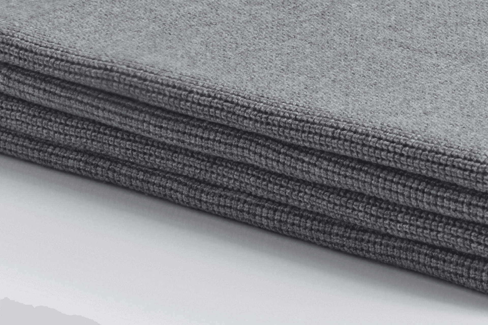 A close-up view of the Bemboka Ultrafine Merino Small Box Throw in shade Pale Grey, showcasing the luxurious softness and intricate weave of fine merino wool fibers.