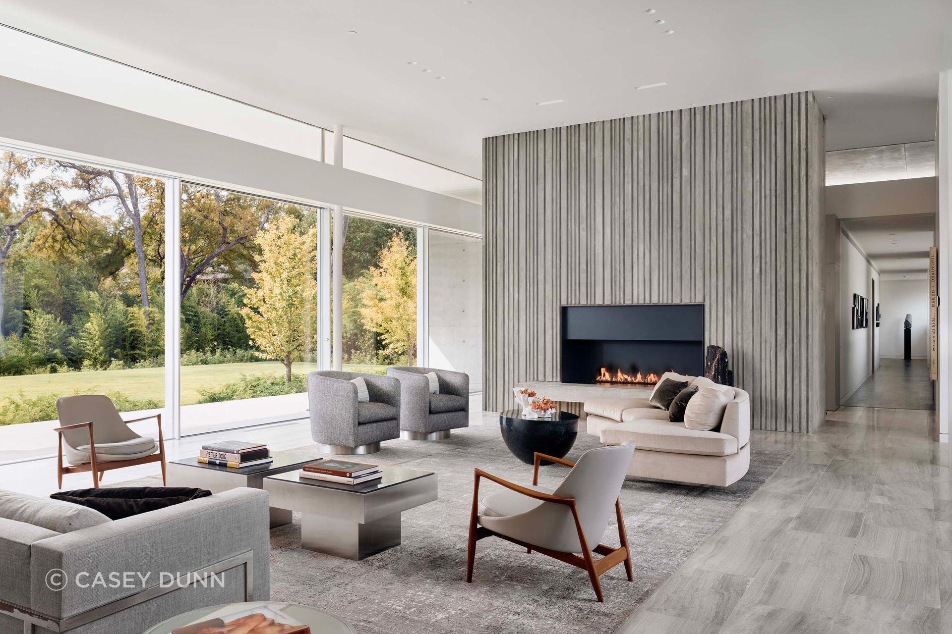 The fireplace brings the project’s textured concrete language inside, turning a highly technical casting process into a calm, tactile focal point for daily living.