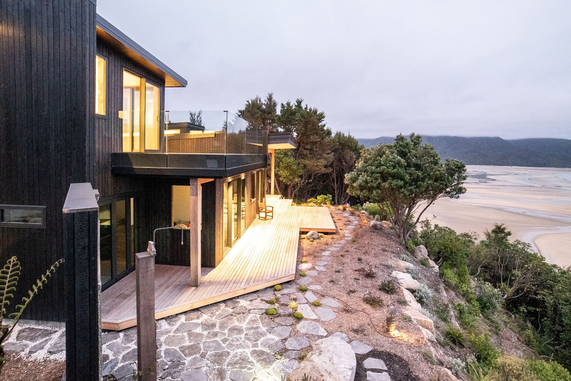 Stone, pebbles and timber — just some of the hardcaping material featured in this stunning coastal home.