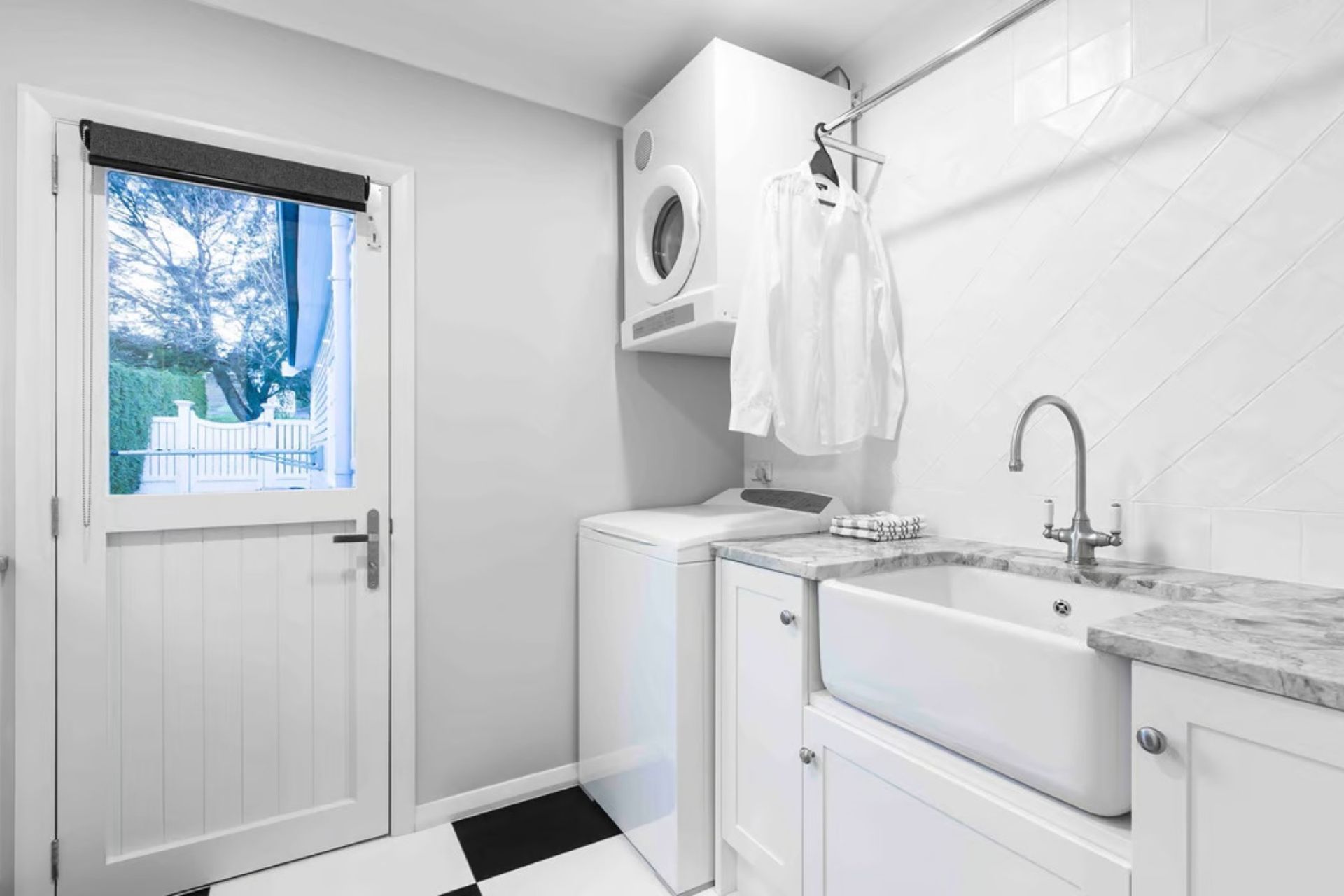 The clothes hanger in this elegant laundry in St Heliers by Celia Visser Design shows how practical an addition it can be.