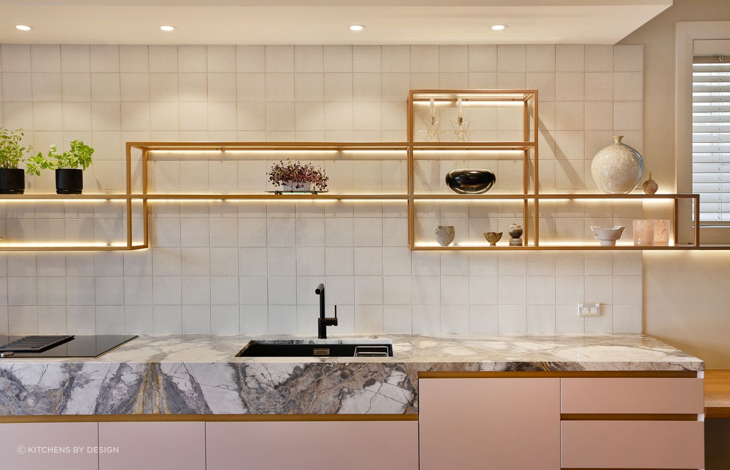Square patterned tiles take centre stage in this immaculate kitchen in St Heliers.