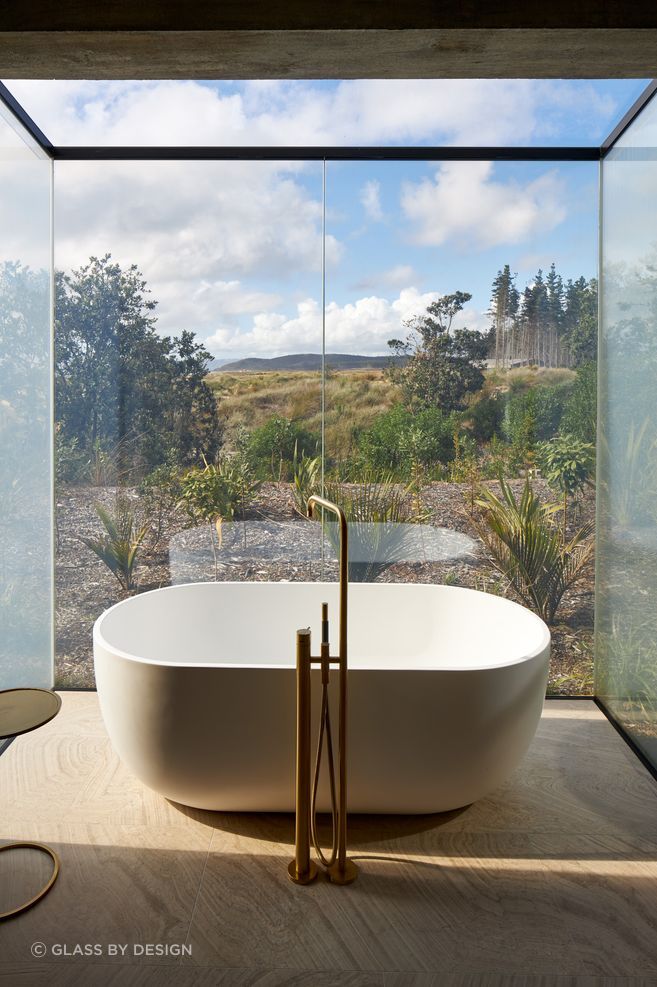 "The bath extended out from the rest of the en-suite on a slab, and we enclosed the sides, front, and roof with switchable glass panels... The clients wanted control over their privacy, with clear glass for an evening bath under the stars, and frosted glass for when family or friends are around."
