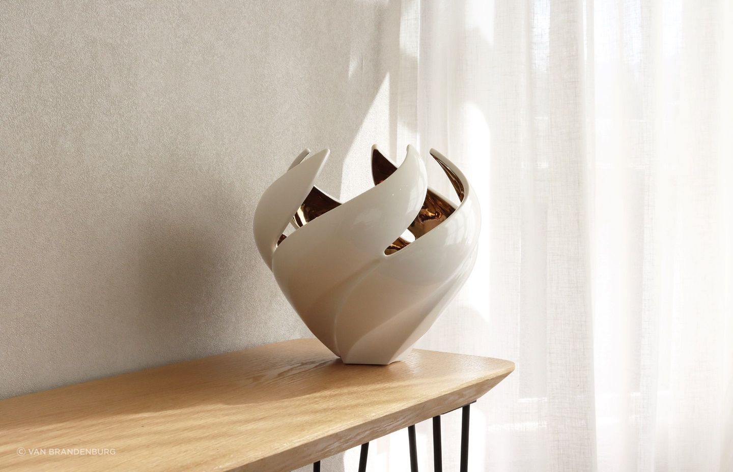 Glossy items of decor, like this exquisite Twisted Vessel vase, can catch lovely highlights on a sunny day.