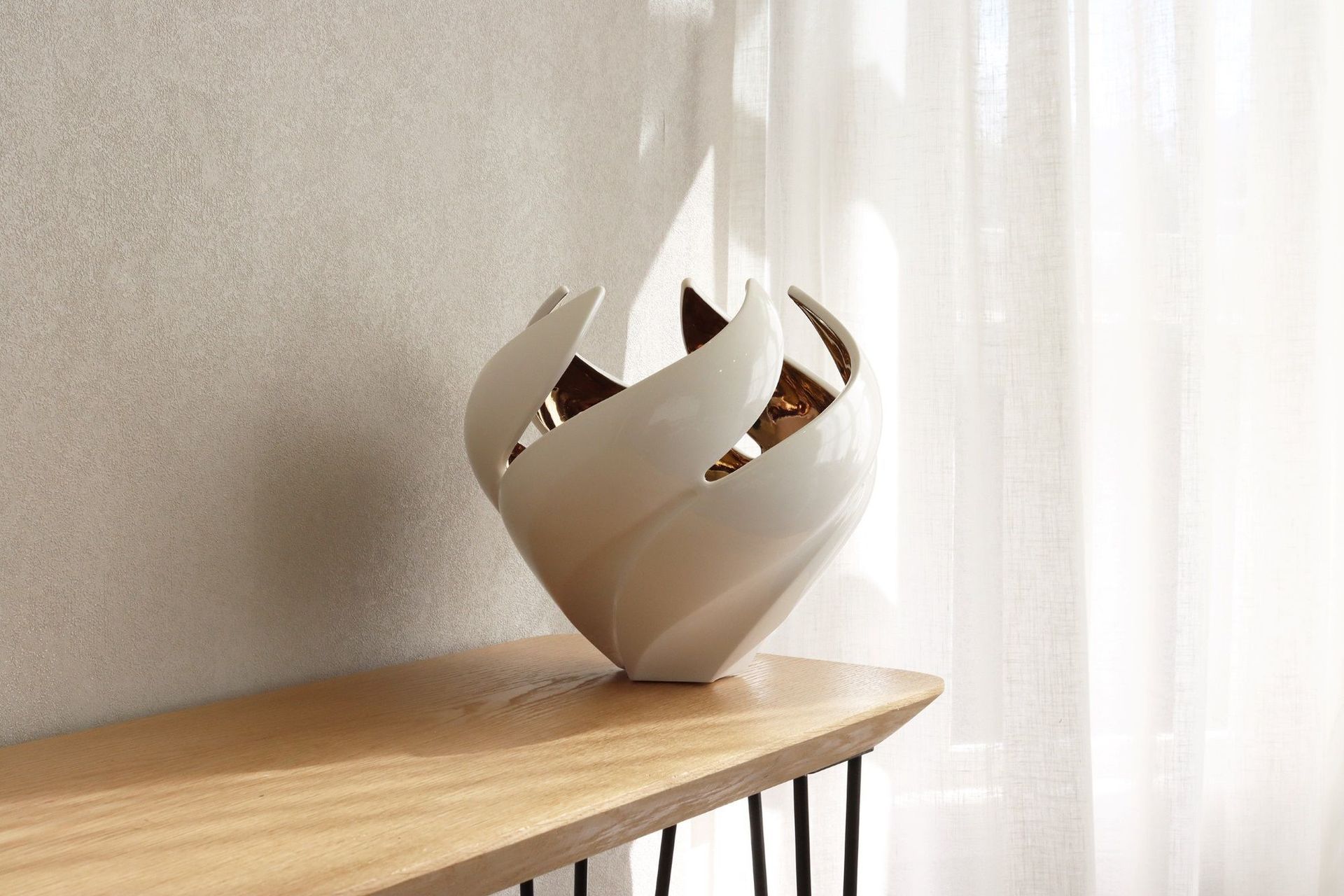 Glossy items of decor, like this exquisite Twisted Vessel vase, can catch lovely highlights on a sunny day.
