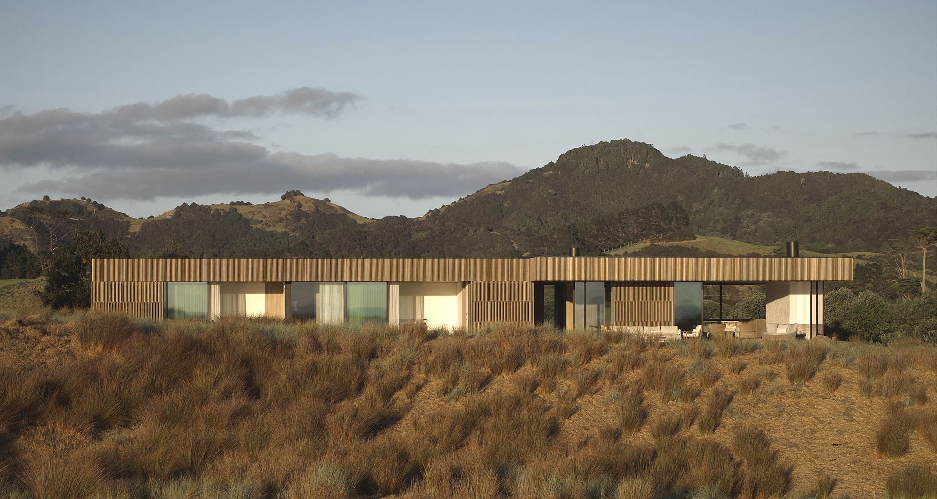 Tahi House sits low within the restored dunes of Pātaua North, its restrained form shaped by site, climate and long-term care for the land.