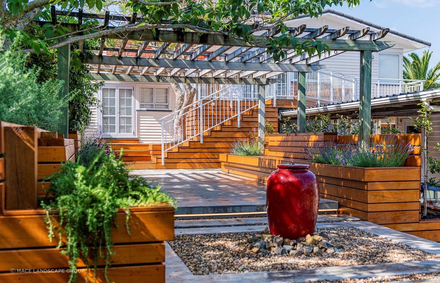 A water feature, like the one featured in this lovely home in Titirangi, can act as a strong focal point for an outdoor living space.