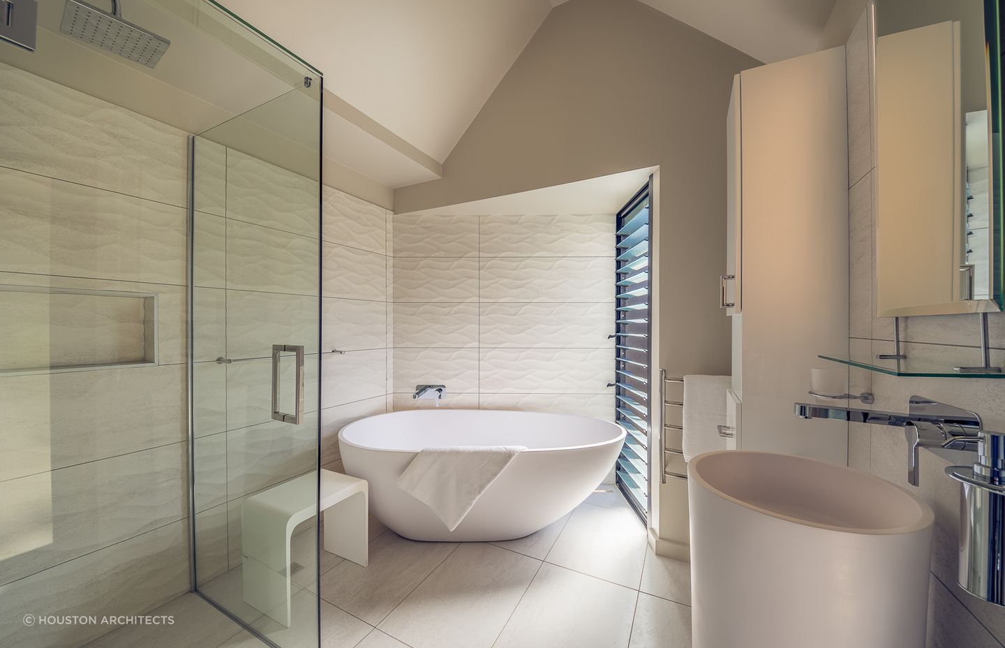 Dimension, depth and direction with the wave form textured tiles used in this Tutukaka bathroom renovation.