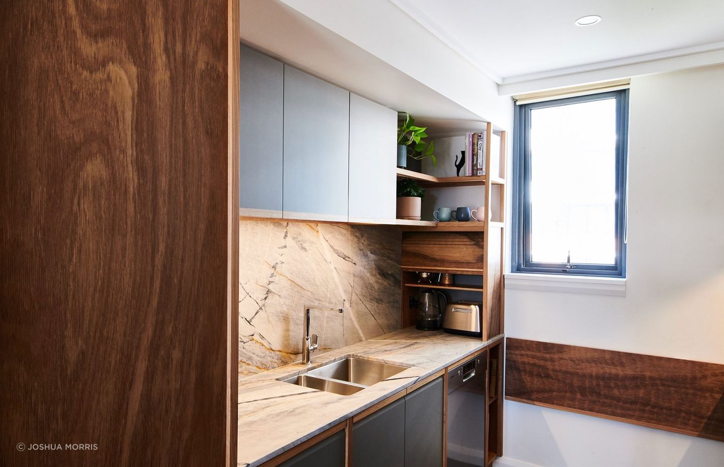 This neat Blackbutt tambour door is a perfect solution for this tidy kitchen in Prymont. | Photography: Joshua Morris