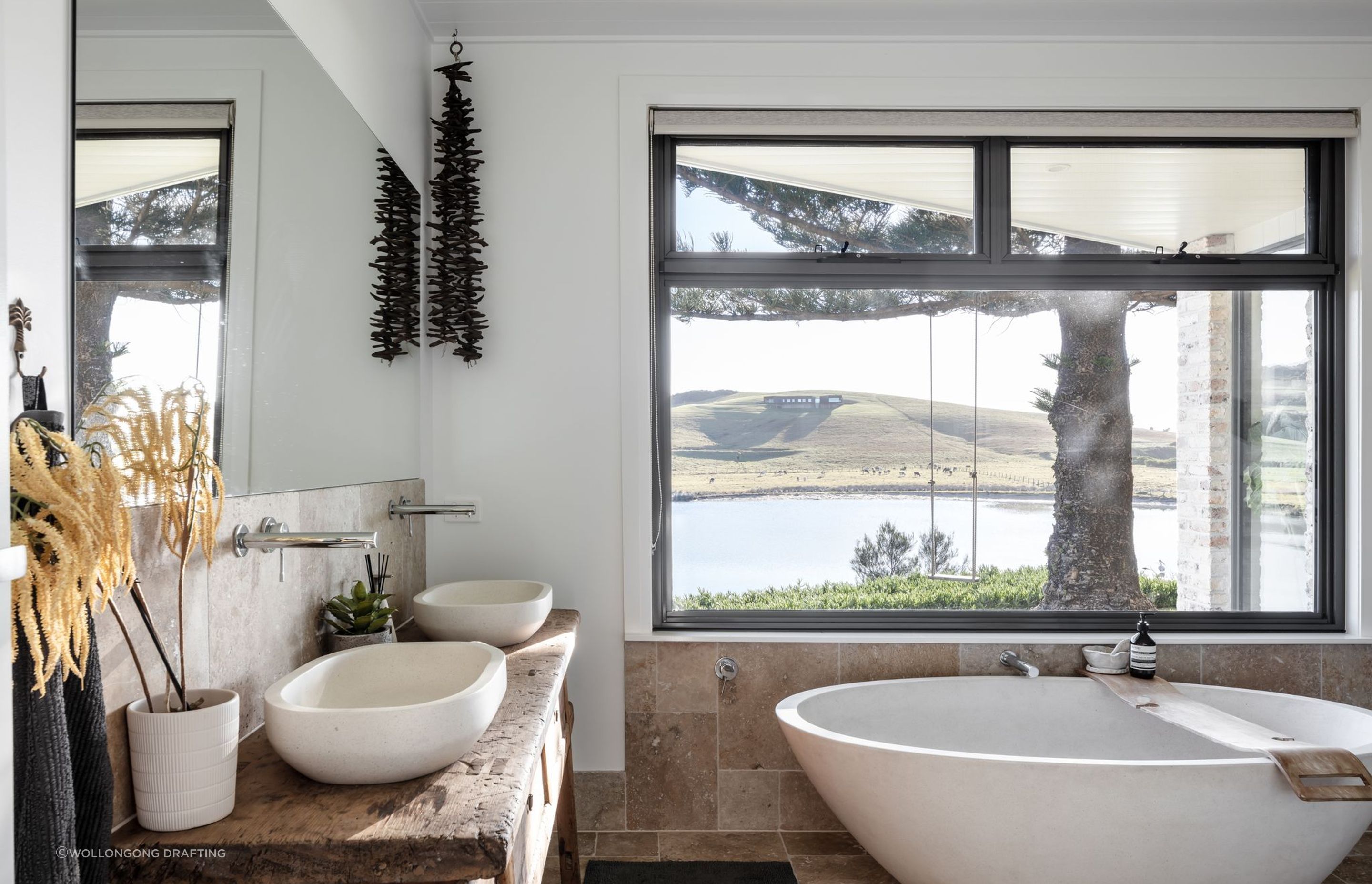 Modern coastal bathrooms seamlessly blend with their natural surroundings, capturing the essence of the shore, particularly in their decor.