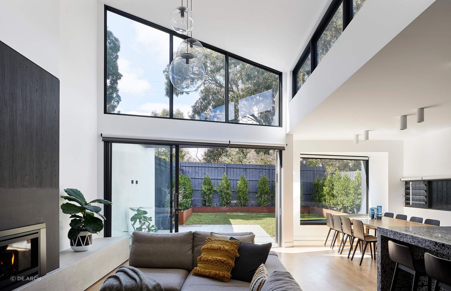 The yellow cushion adds a touch of brightness to this grey sofa. Featured project: Ashburton Townhouse.