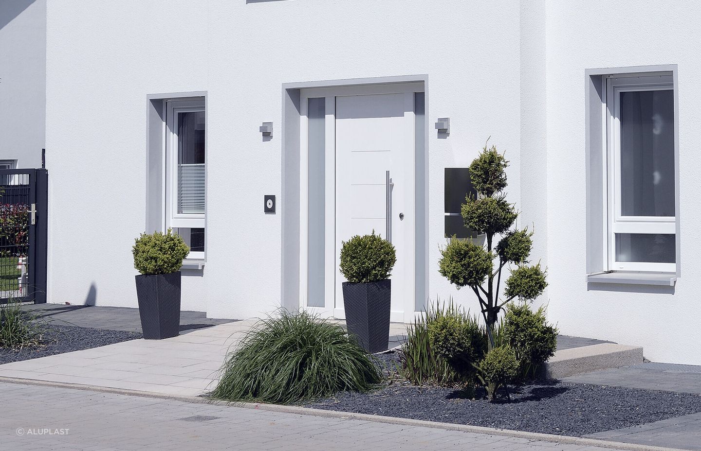 The pristine white PVC door, central to this home's facade, is not only visually appealing but also offers plenty of practical benefits.