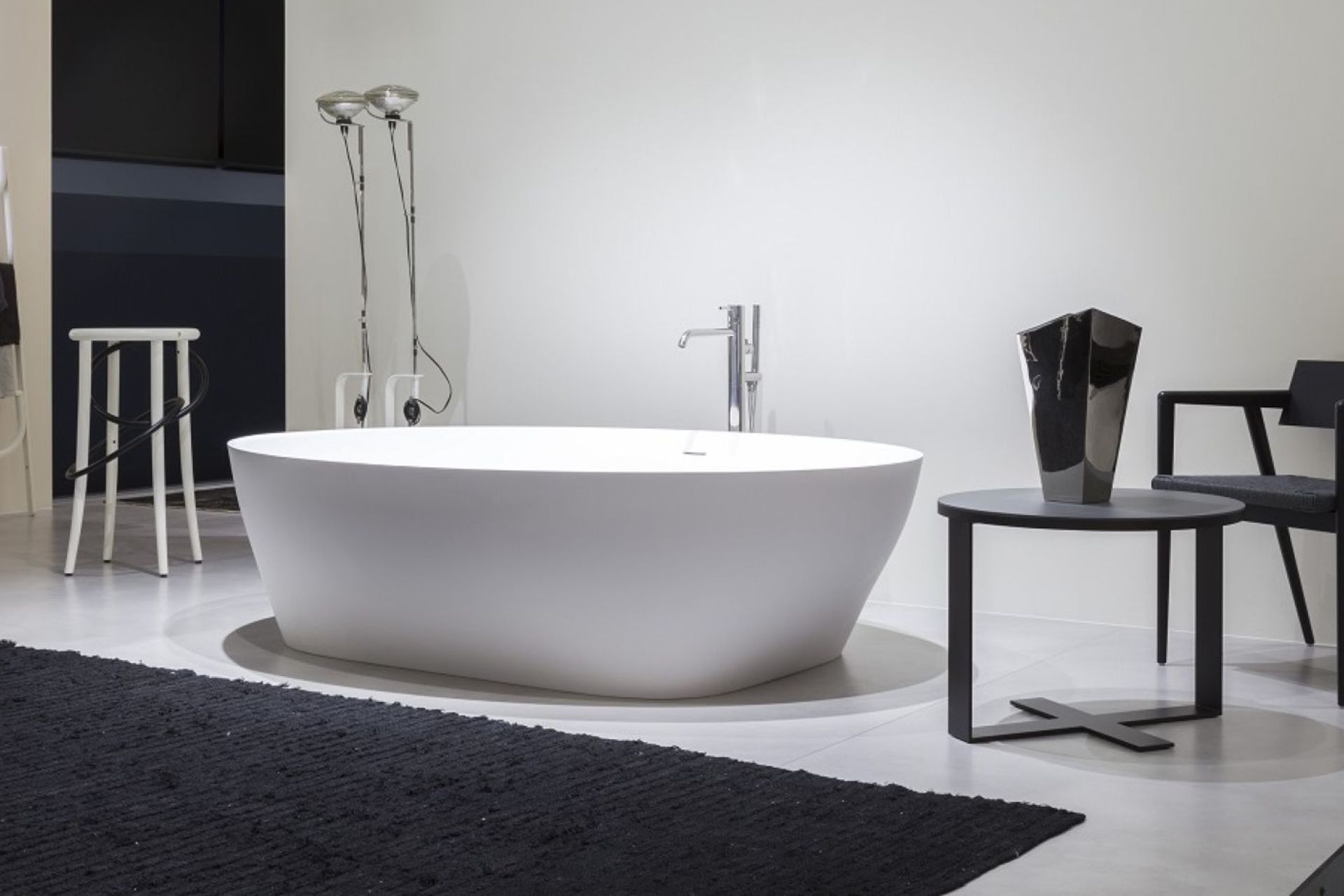 A high-quality bathroom mat, like that complementing the exquisite Solidea Bath by AntonioLupi, is a great way to create a feeling warm underfoot.