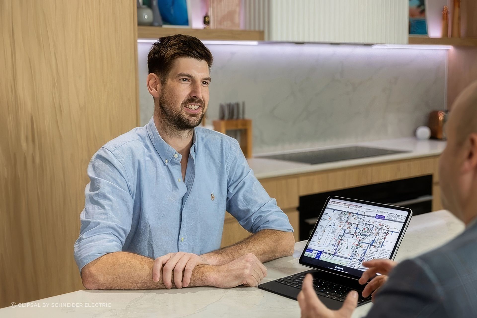 client-smiling-while-discussion-with-clipsal-consultant-875x492-ap-compressed-upscaled-by-Replicate.jpg