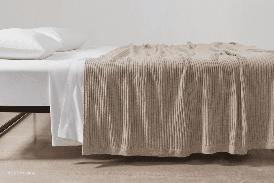 Bemboka Wide Rib Angora and Merino Wool Blanket in wheat shade paired with crisp percale cotton sheeting creates a soft, inviting, and stylish layering perfect for a cosy winter bedroom.